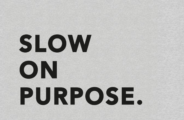 Slow on Purpose in dark grey on a light grey background - SNURK